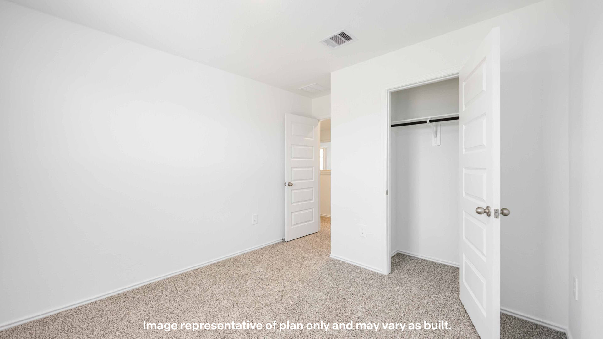 Guest bedroom with plush carpet floors and spacious closet