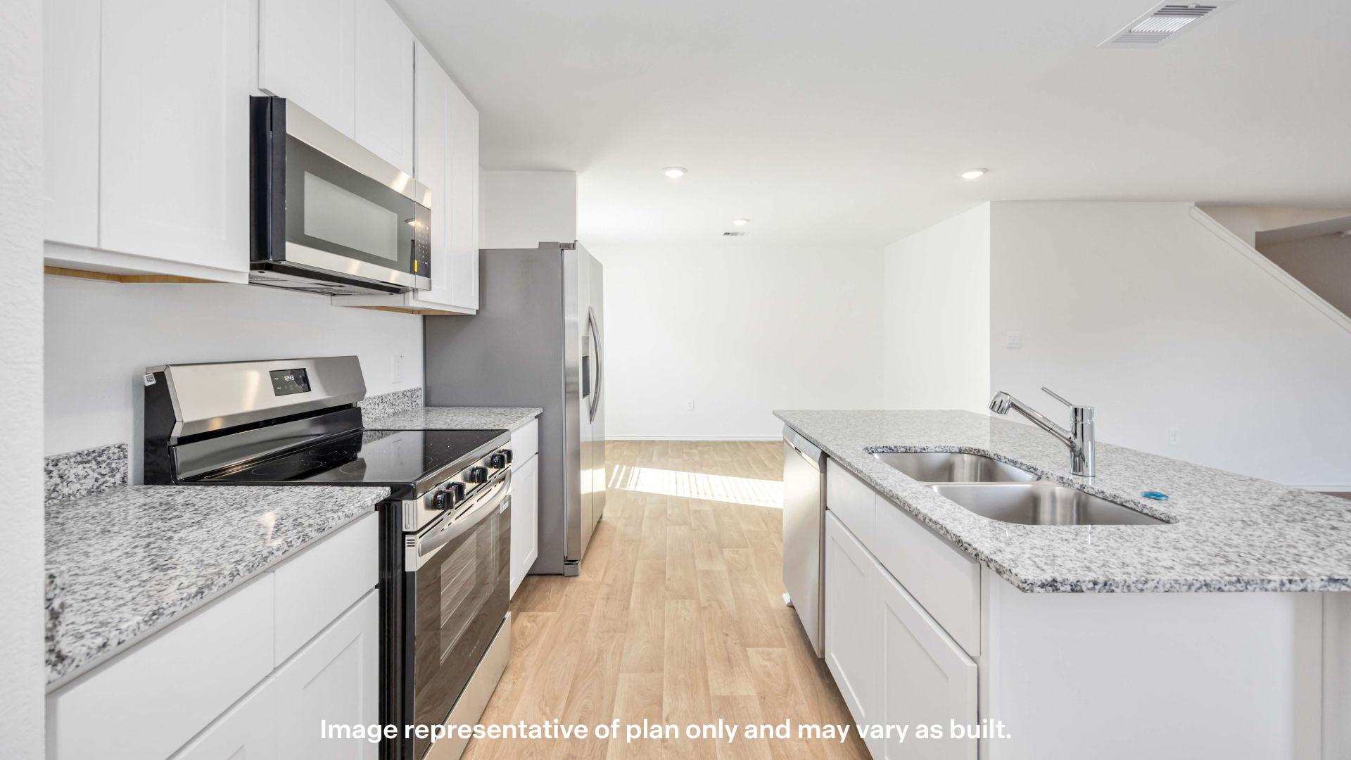 Open concept kitchen with stainless steel appliances, shaker style cabinets, and elevated finishes
