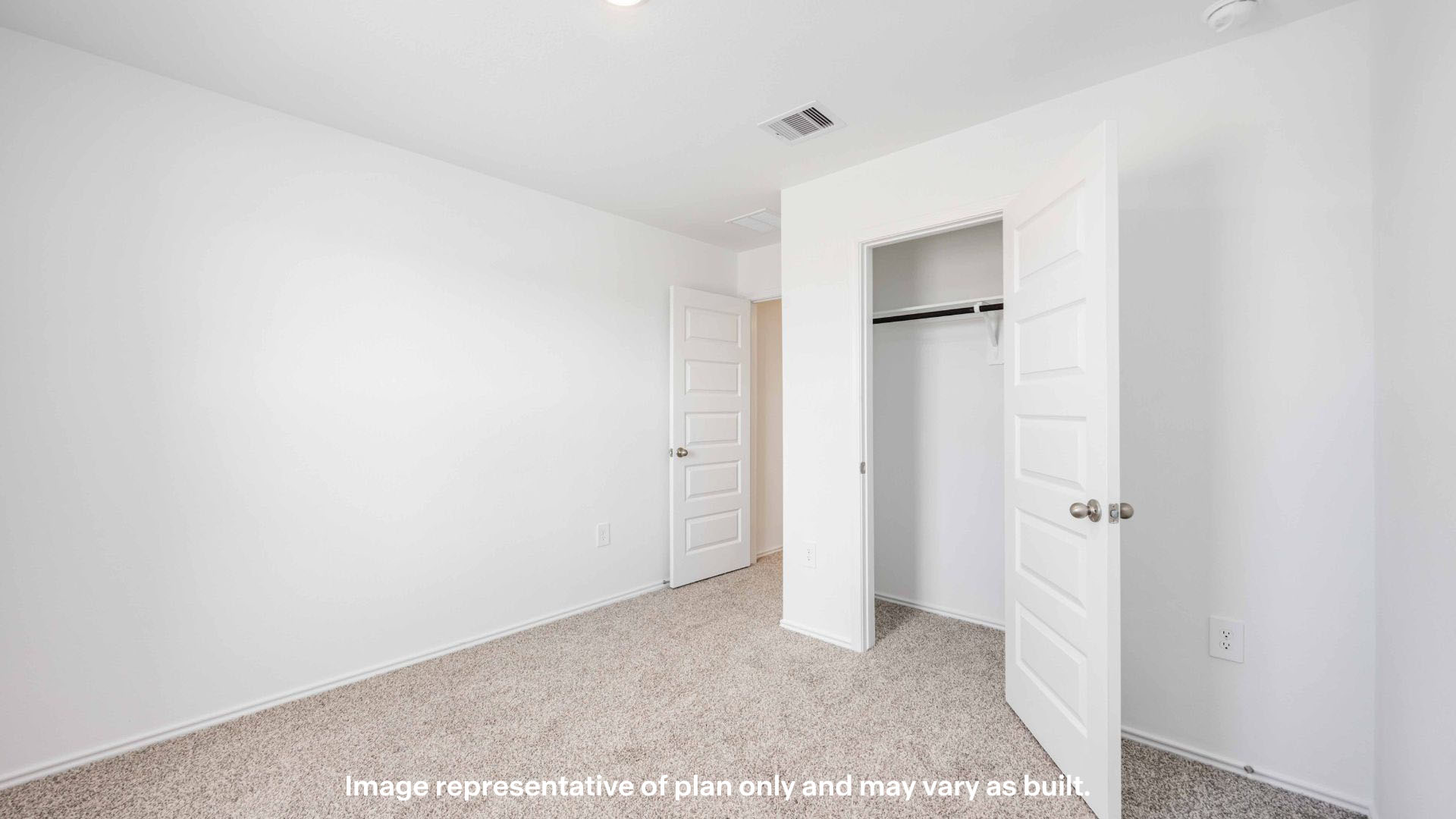 Guest bedroom with plush carpet floors and spacious closet