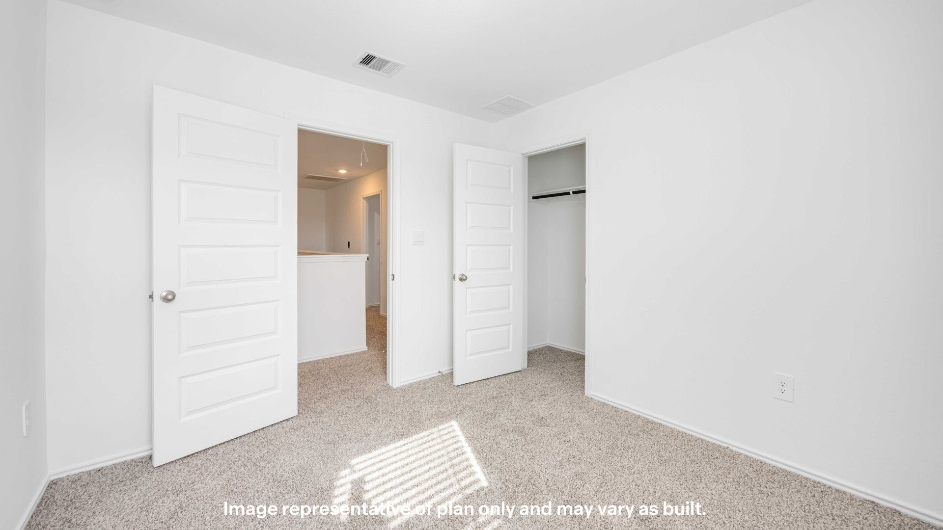 Guest bedroom with plush carpet floors and spacious closet