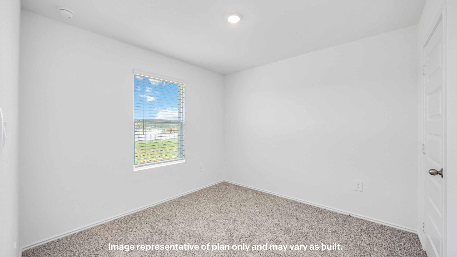 Guest bedroom with front window and plush carpet floor