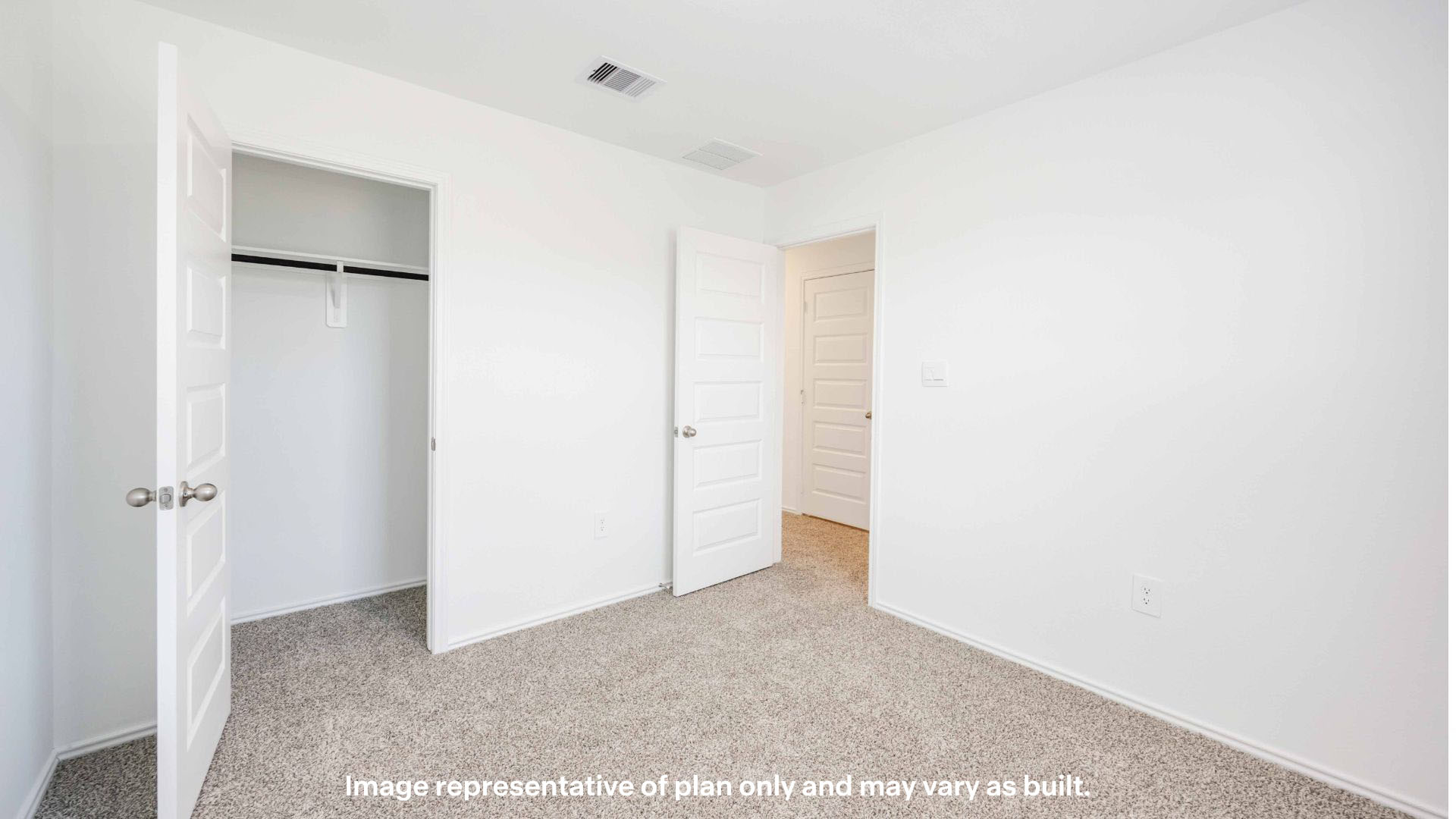 Guest bedroom with plush carpet floors and spacious closet