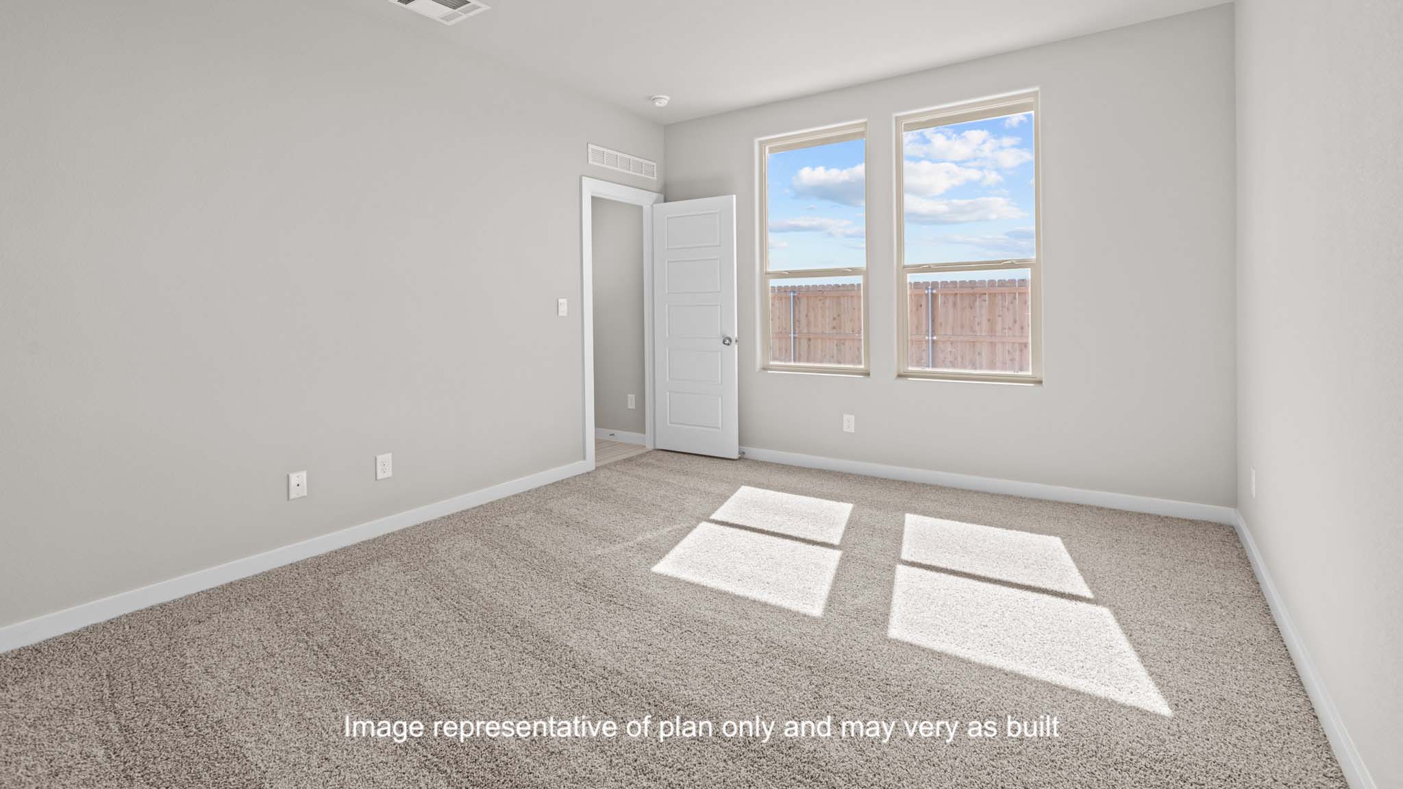 Primary bedroom with plush carpet floors and light allowing double windows