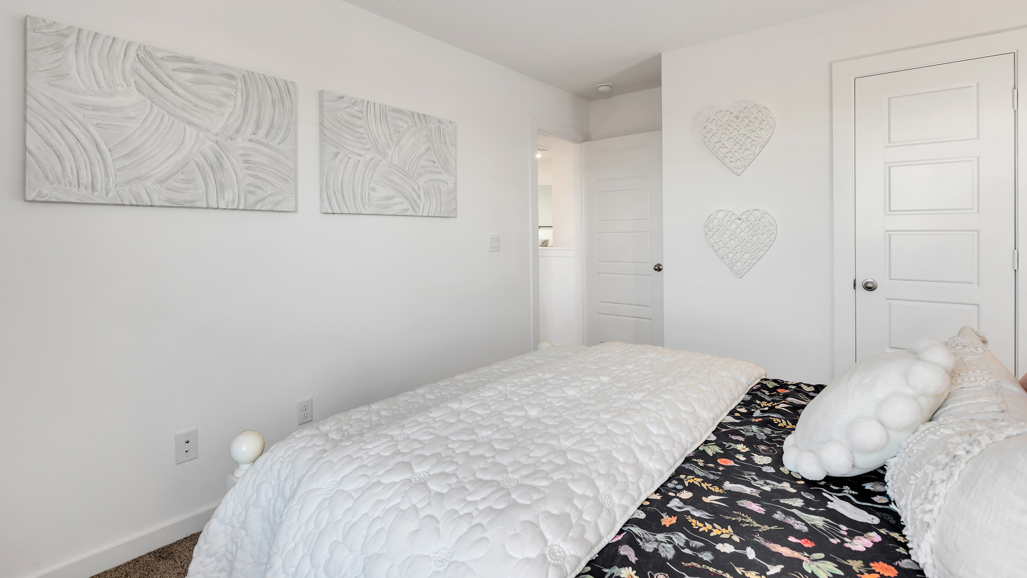 Guest bedroom 1 with plush carpet floors and spacious closet