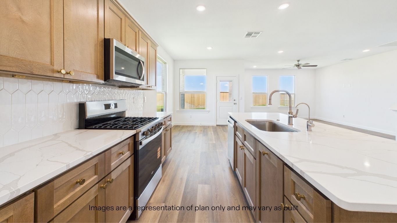 Open concept kitchen with stainless steel appliances, shaker style cabinets, and elevated finishes