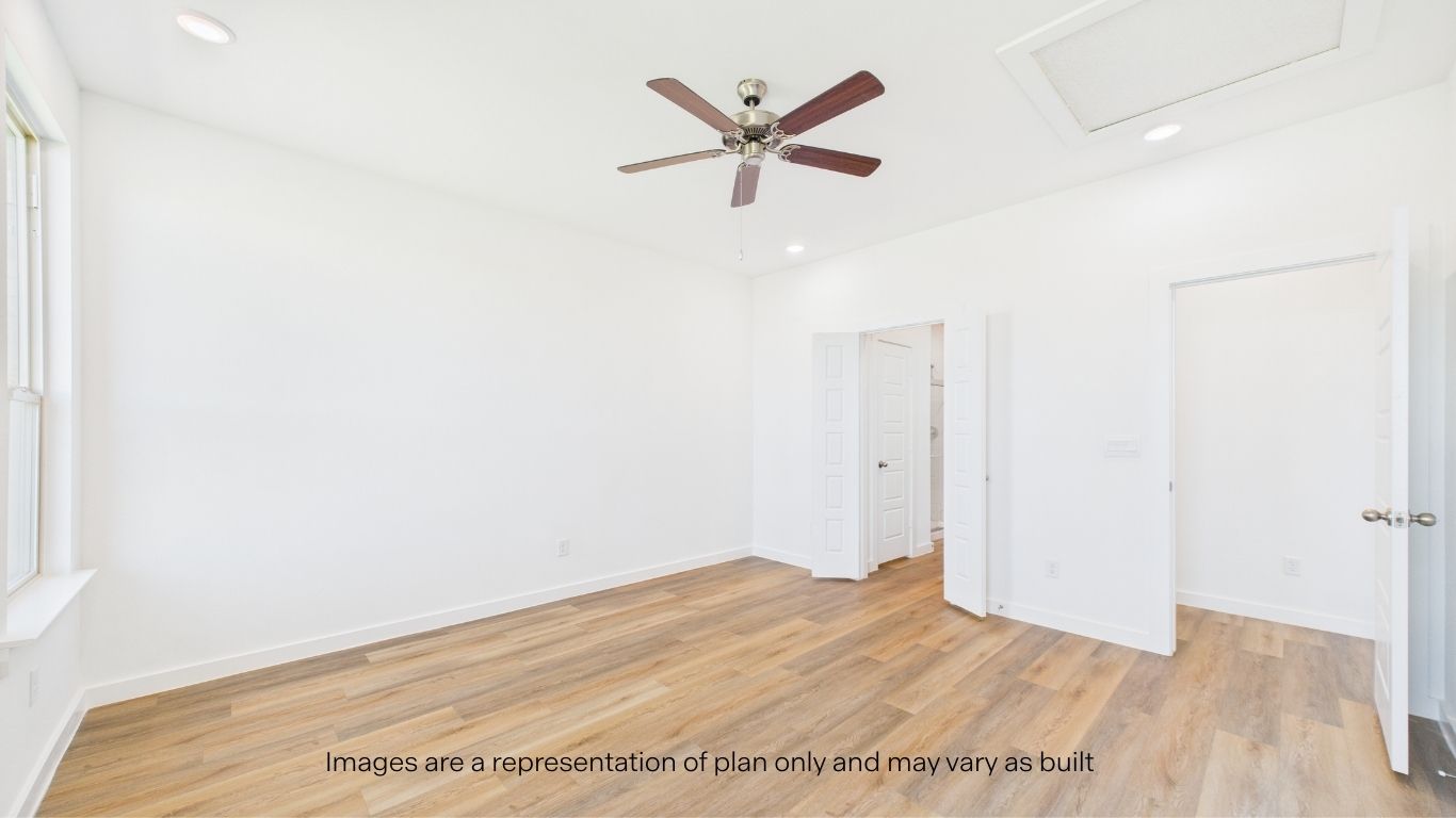 Primary bedroom with private attached bathroom and walk-in closet