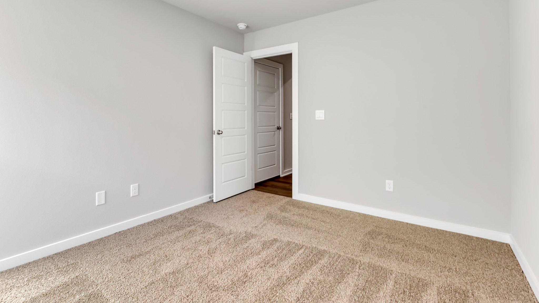 Guest bedroom with plush carpet floors and spacious closet
