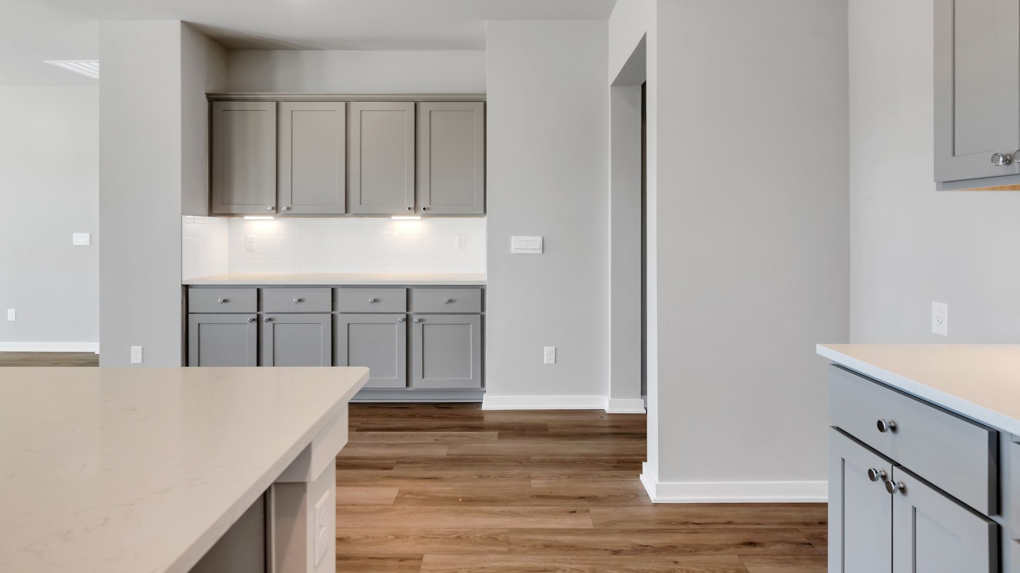 Open concept kitchen with stainless steel appliances, shaker style cabinets, and elevated finishes