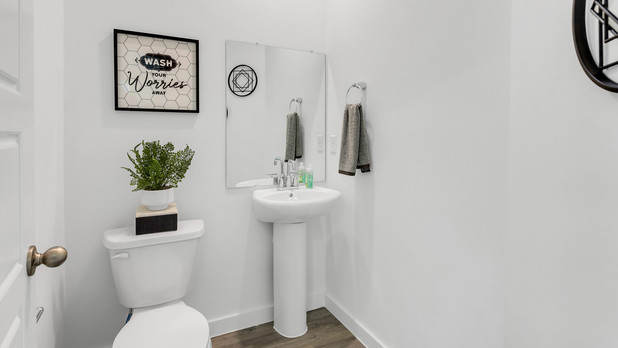 Downstairs half bath located between staircase and primary room