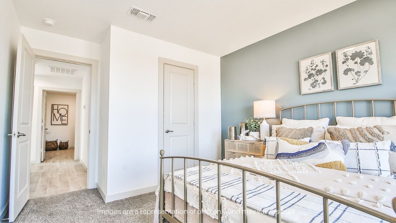 Guest bedroom 1 with plush carpet floors and spacious closet