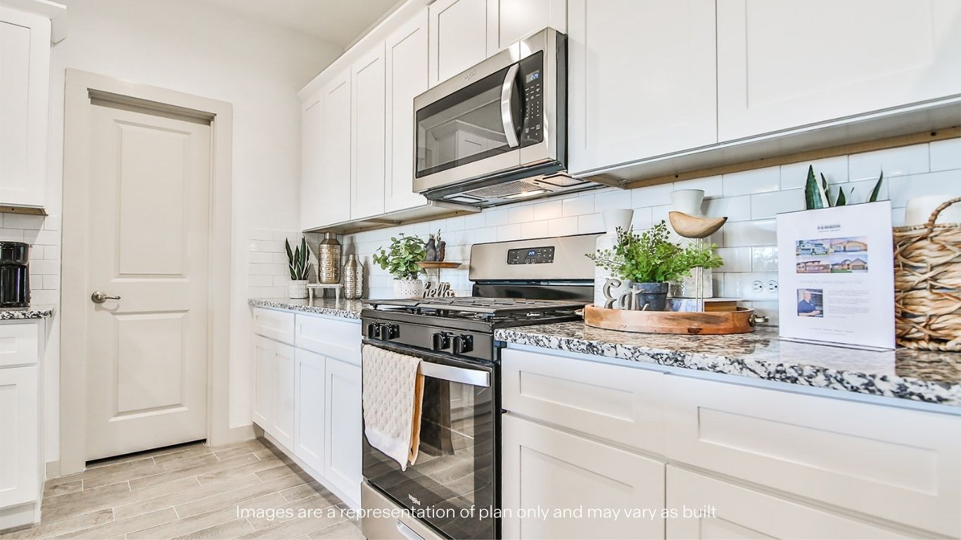 Open concept kitchen with stainless steel appliances, shaker style cabinets, and elevated finishes