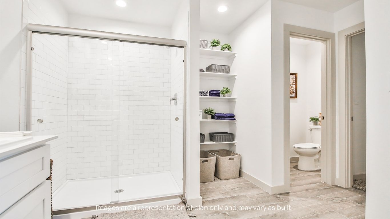 Primary bathroom with luxurious shower and built in storage