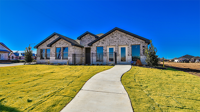 Single story home with brick, stone, covered patio with 2 car garage
