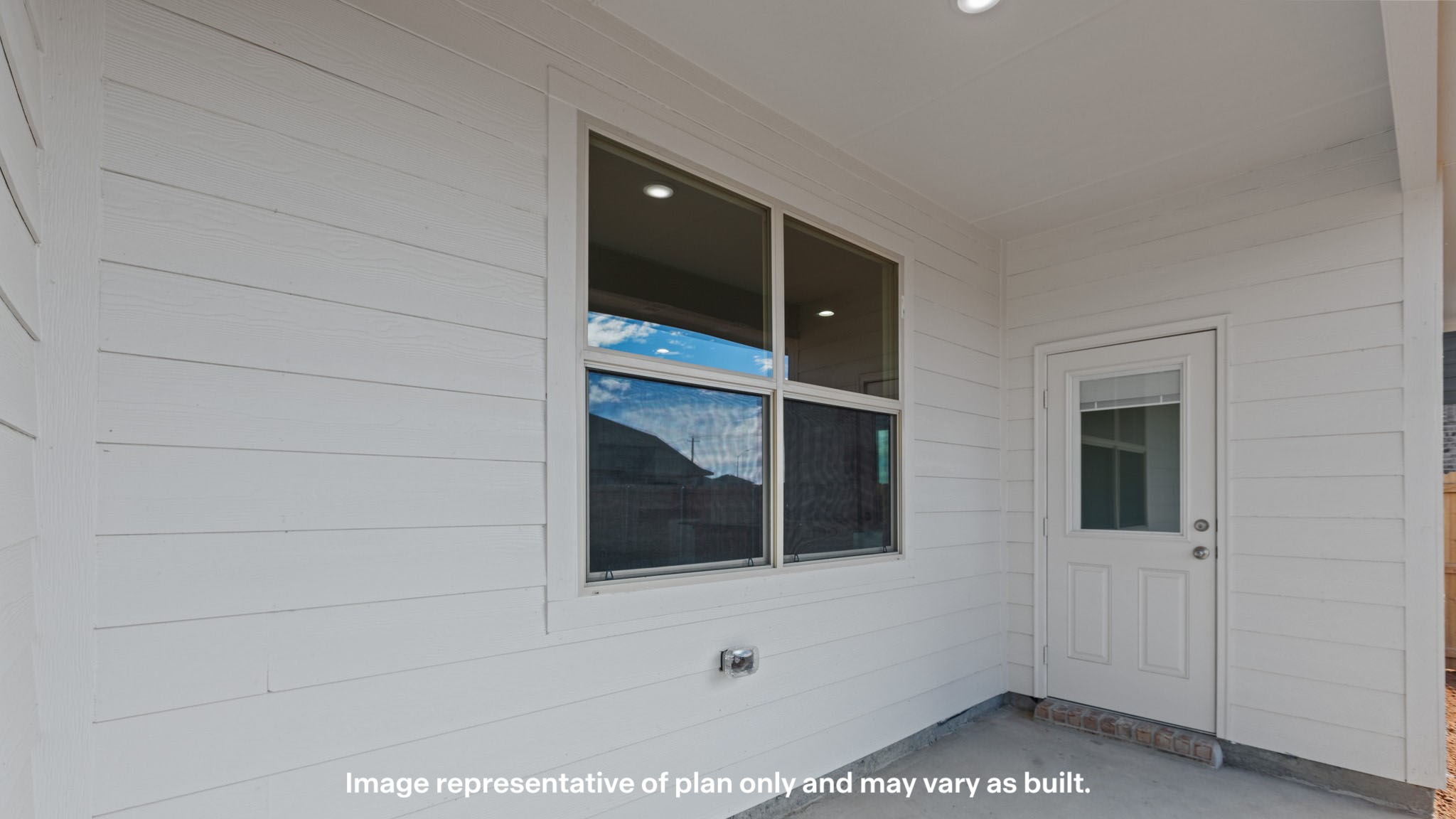 Covered back patio area overlooking spacious backyard