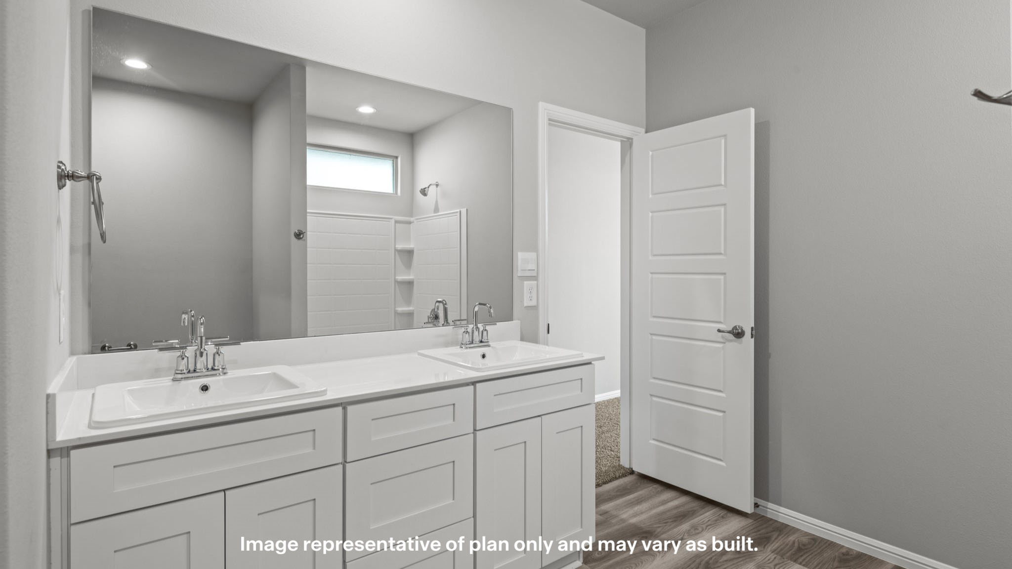 Private attached primary bathroom with built in vanity and luxurious shower