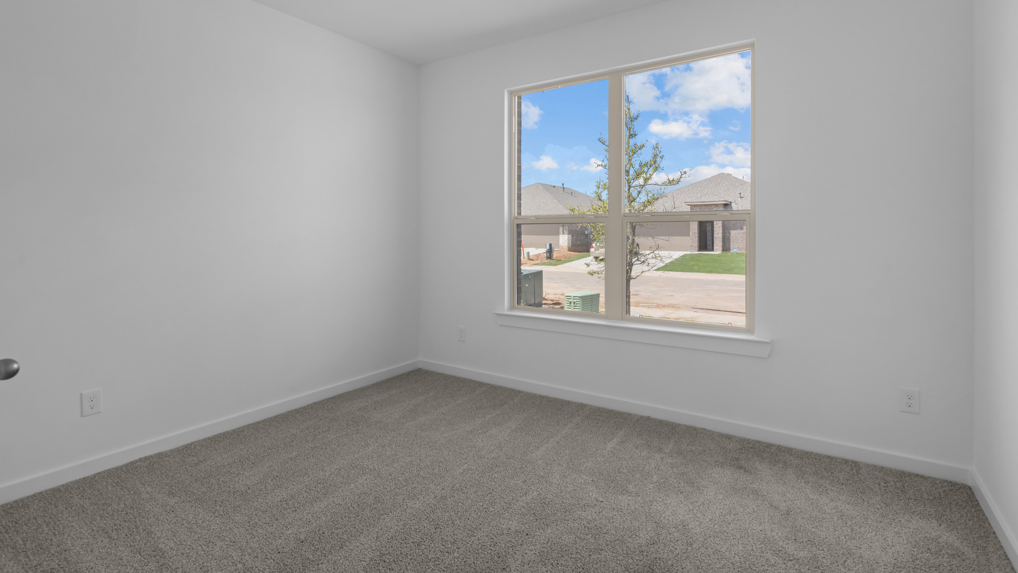 Guest bedroom 1 with front windows and ample natural light