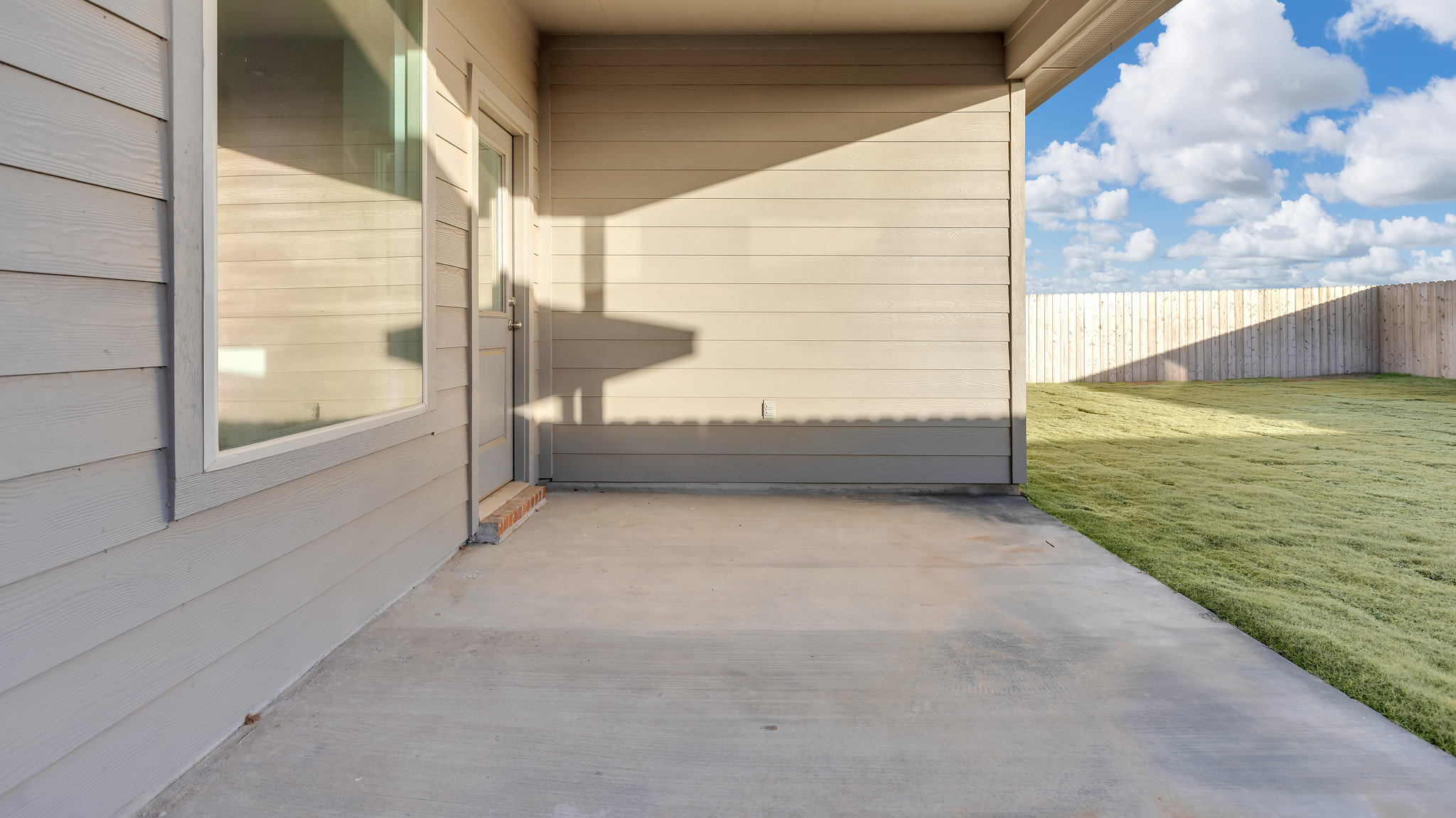Covered patio area overlooking backyard