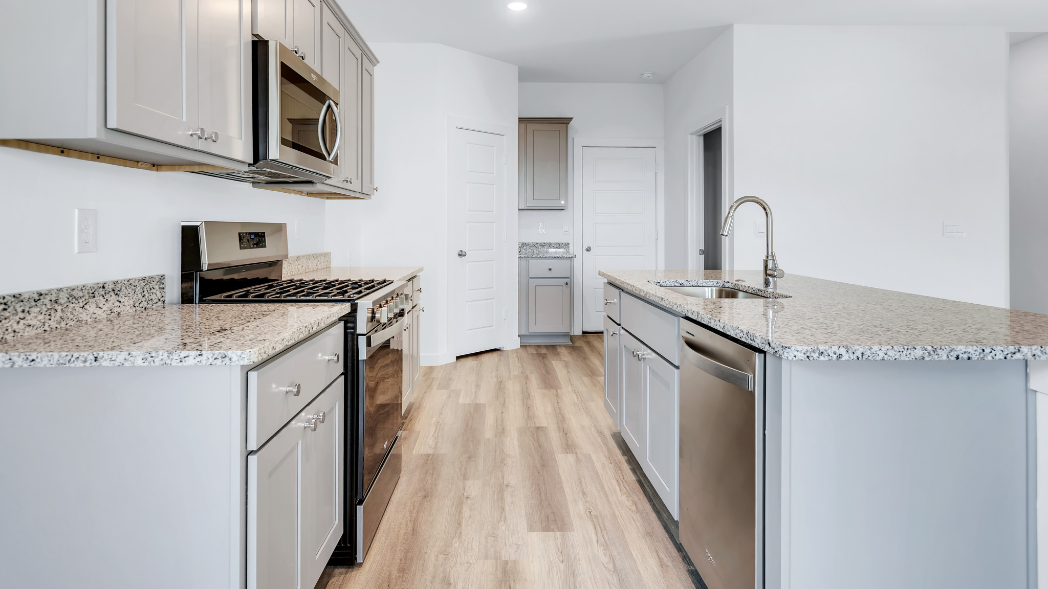 Modern kitchen with stainless steel appliances and shaker style cabinets