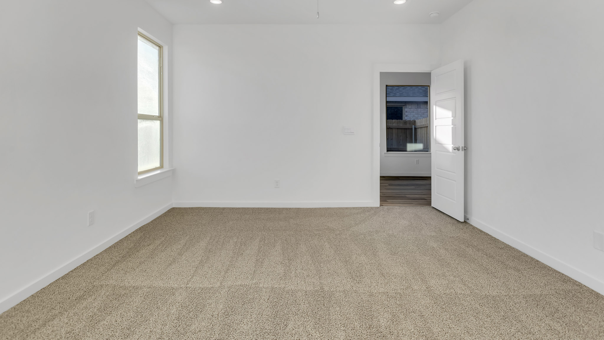 Primary room with attached walk in closet and private bathroom