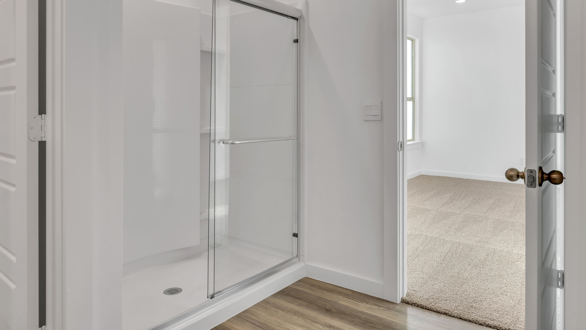 Primary room bathroom with luxurious glass door shower
