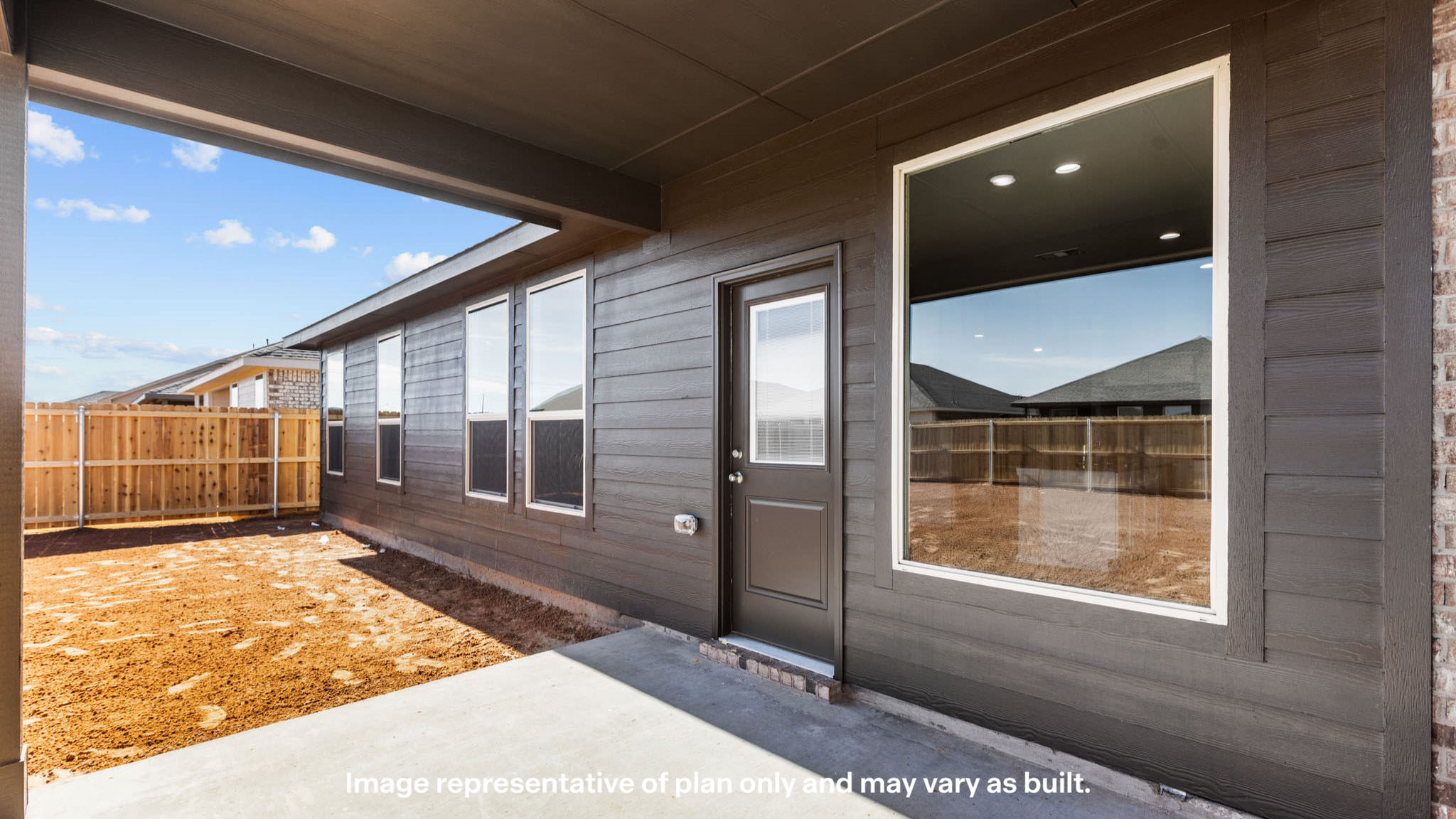 Covered back patio area overlooking private fenced-in backyard