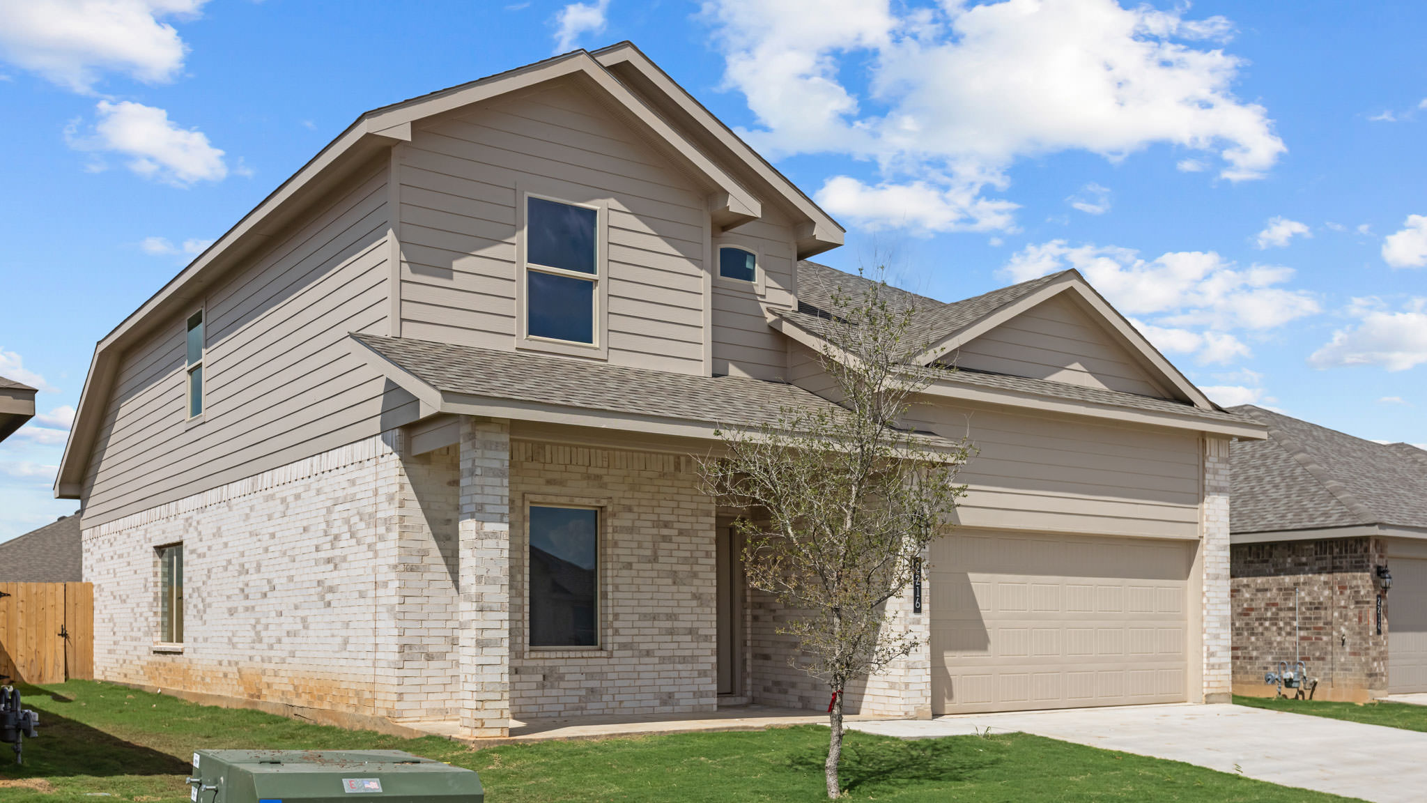 Side view of two story timeless brick home