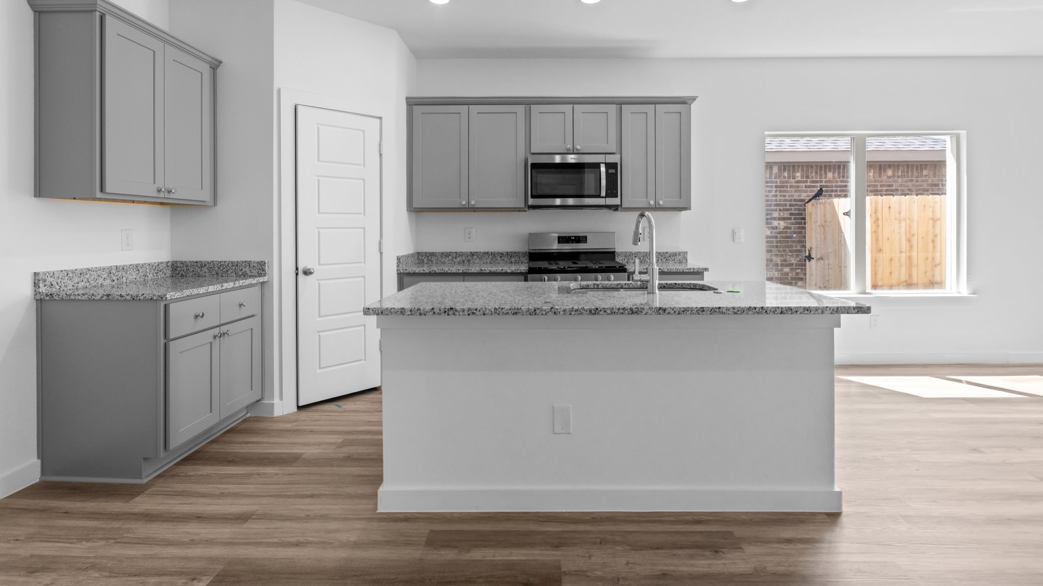 Spacious open concept kitchen with island and counter prep space