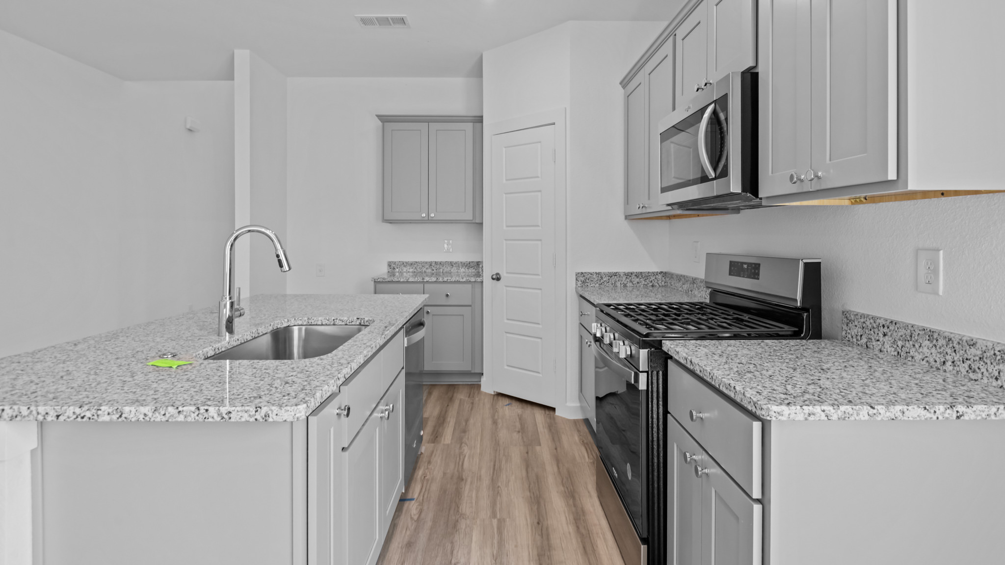 Kitchen with stainless steel appliances, shaker style cabinets, and elevated finishes