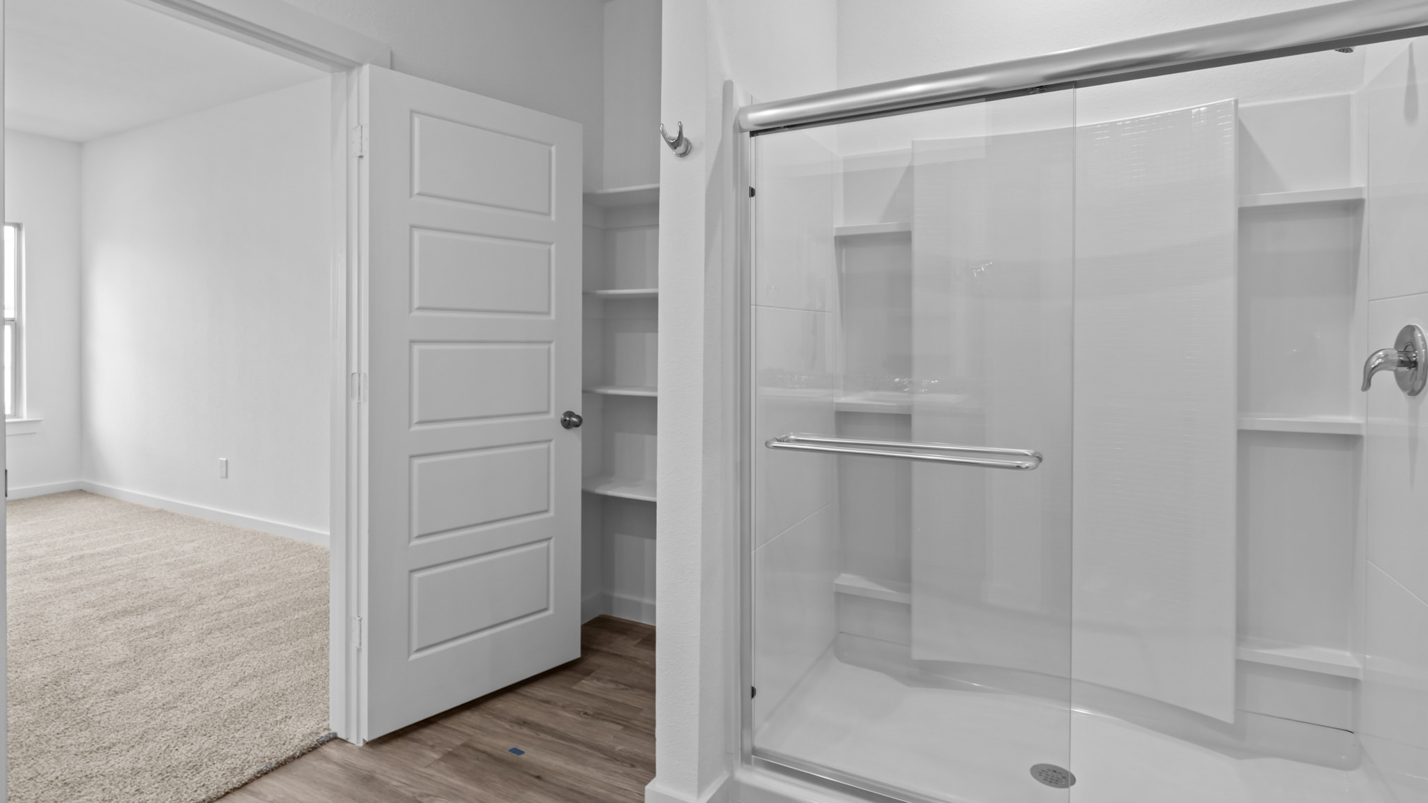 Primary bathroom with luxurious shower and built in storage