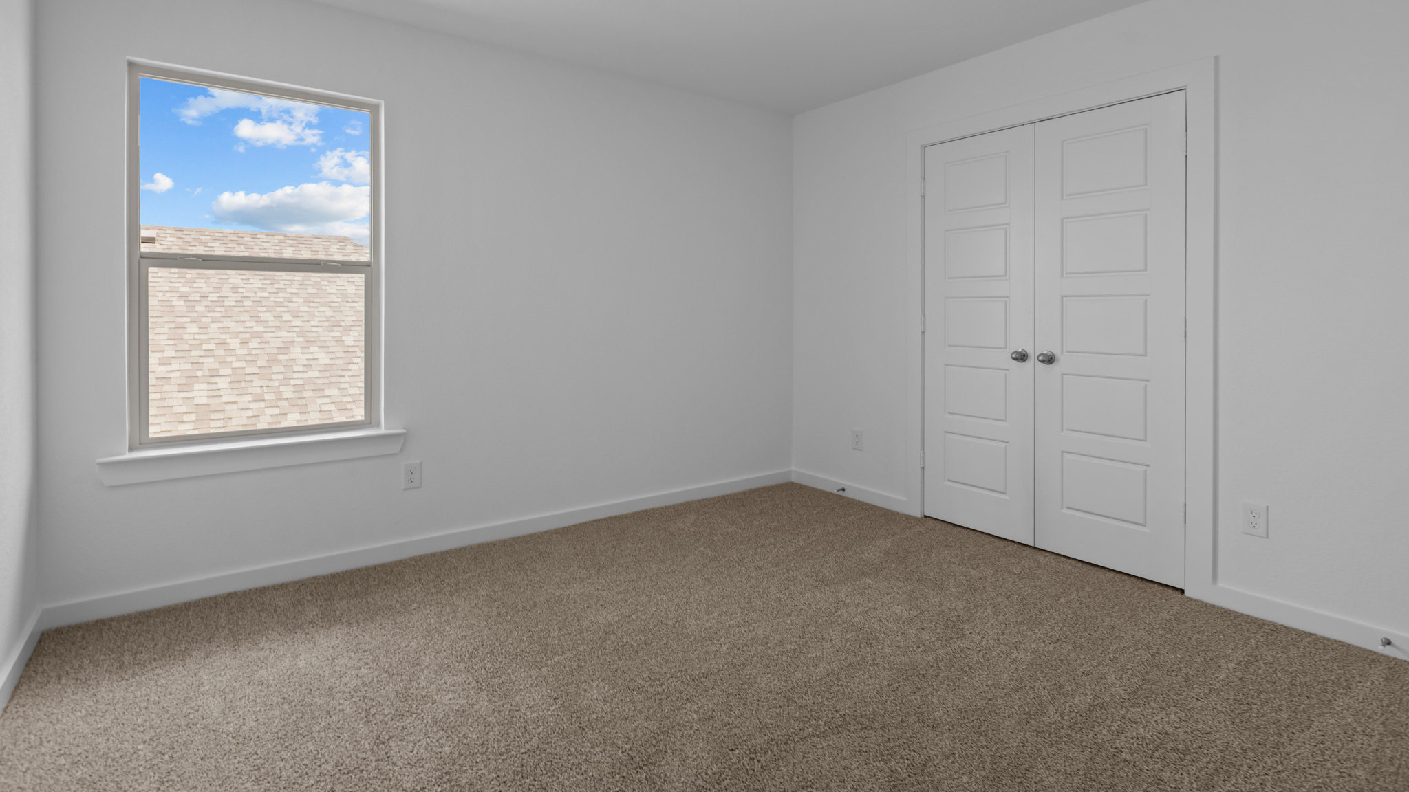 Upstairs guest bedroom 3 with plush carpeted floors and ample natural light