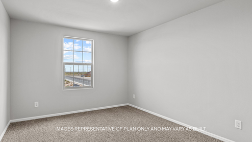 guest bedroom with plush carpet and spacious closet