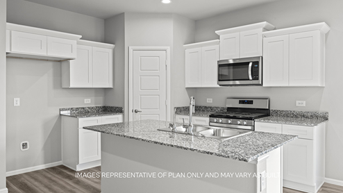 kitchen with spacious island, quartz counters and stainless-steel appliances