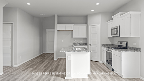 kitchen with spacious island, quartz counters and stainless-steel appliances