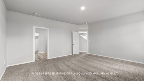 primary bedroom with plush carpet and attached bathroom