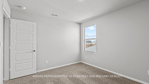 guest bedroom with plush carpet and spacious closet