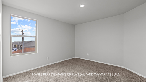 guest bedroom with plush carpet and spacious closet