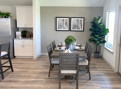 Dining area with windows overlooking backyard