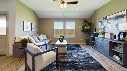 Open airy living area with windows overlooking backyard