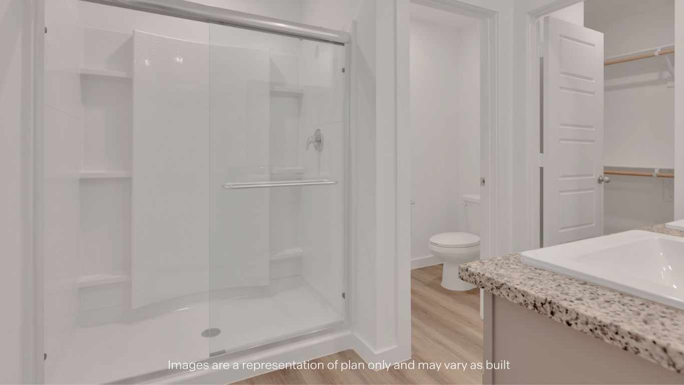 Primary bathroom with built in vanity and luxurious shower