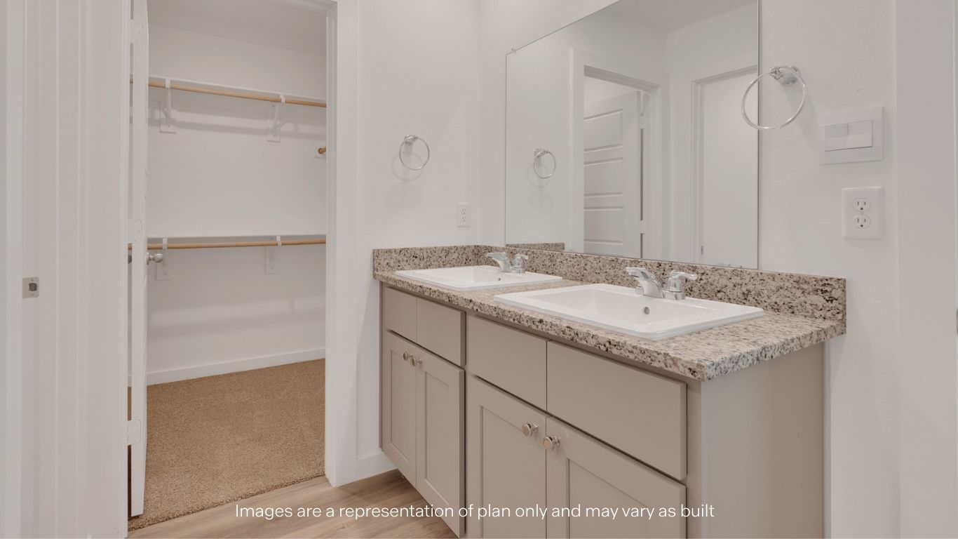 Primary restroom with built in vanity and walk in closet