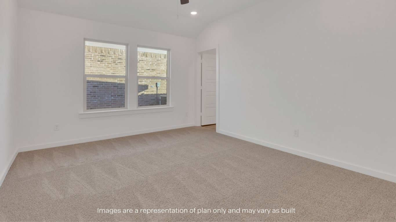 Primary bedroom with plush carpet floors and light allowing double windows