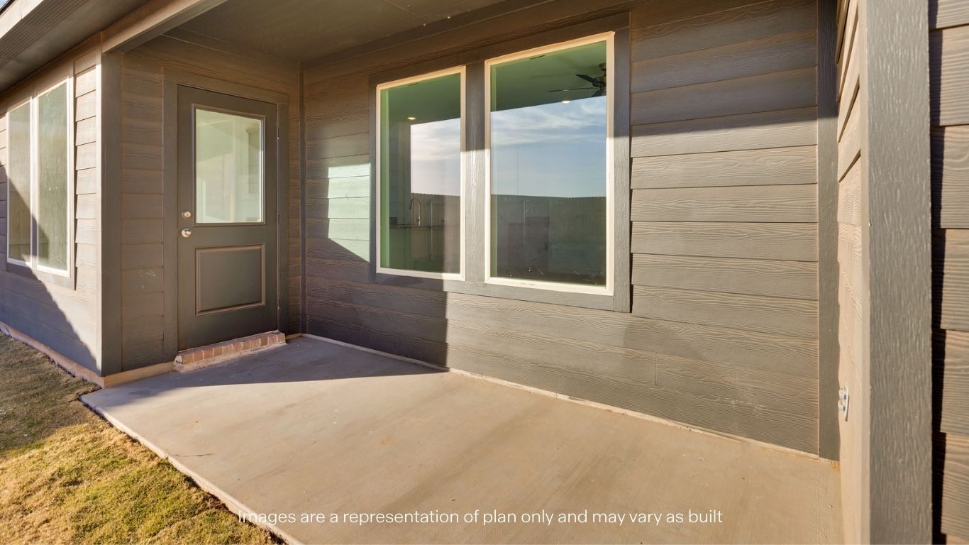 Covered back patio area overlooking spacious backyard