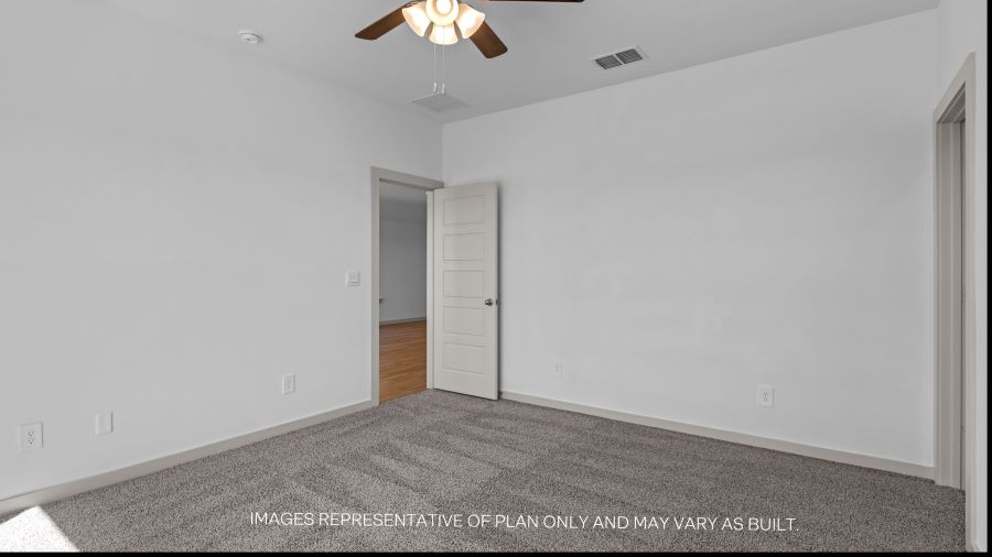 Primary bedroom with plush carpet floors and light allowing double windows
