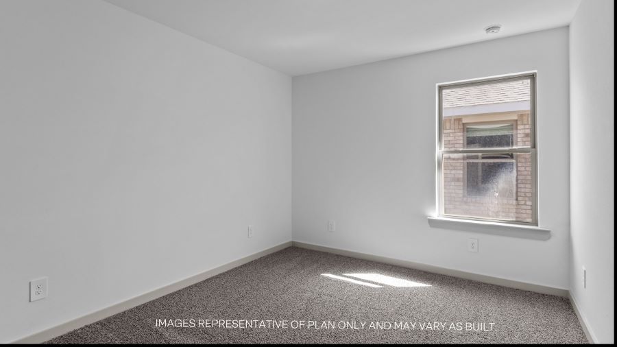 Guest bedroom 1 with side window and plush carpet floor