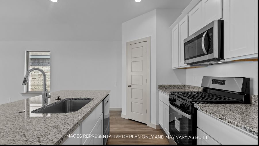 Open concept kitchen with stainless steel appliances, shaker style cabinets, and elevated finishes