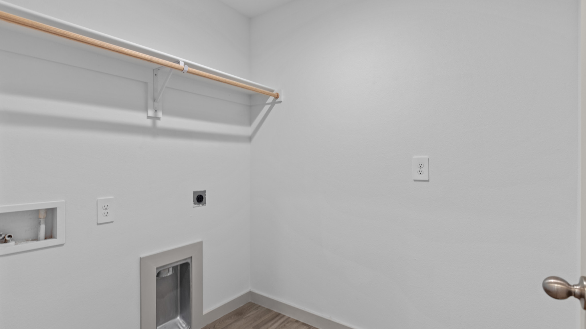 utility and laundry room with shelving