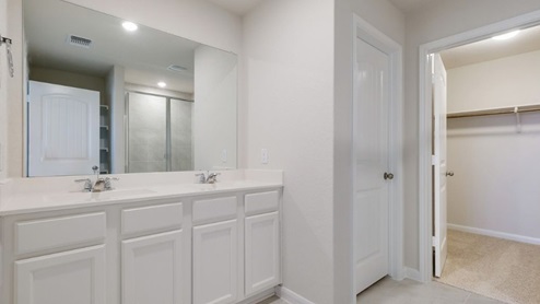 spacious primary bathroom with double vanity