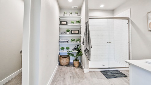 Primary bathroom with large shower with sliding doors