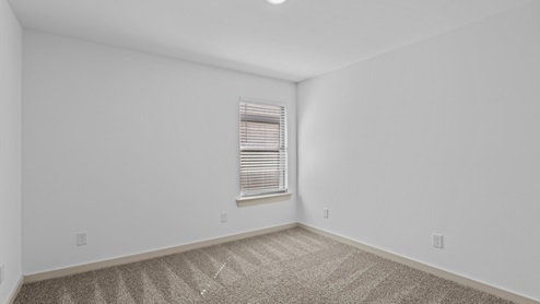 Guest bedroom with plush carpet