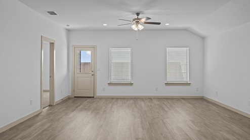 Interior family room area with vinyl flooring overlooking backyard